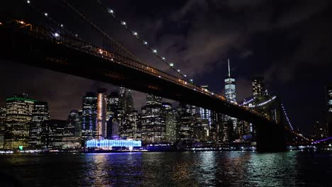 manhattan at night with brooklyn bridge in foreground