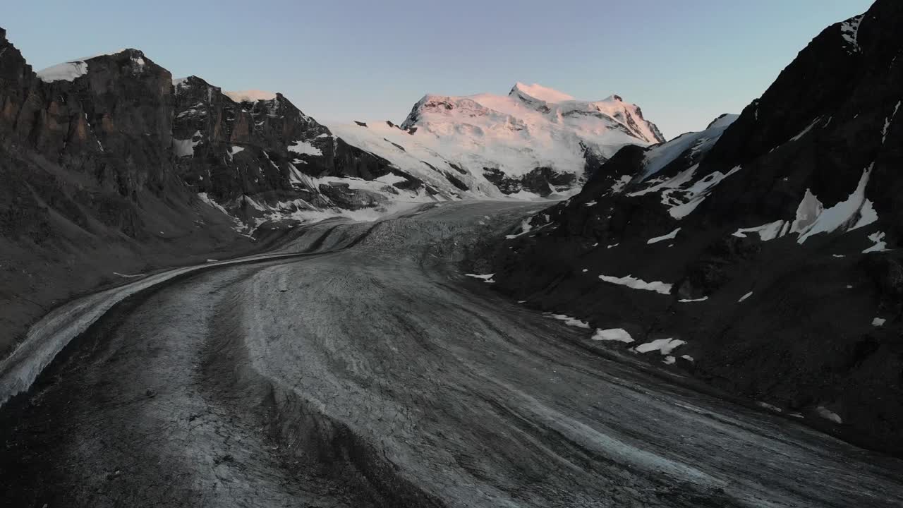 Aerial flyover over Corbassiere glacier in Valais, Switzerland at dusk