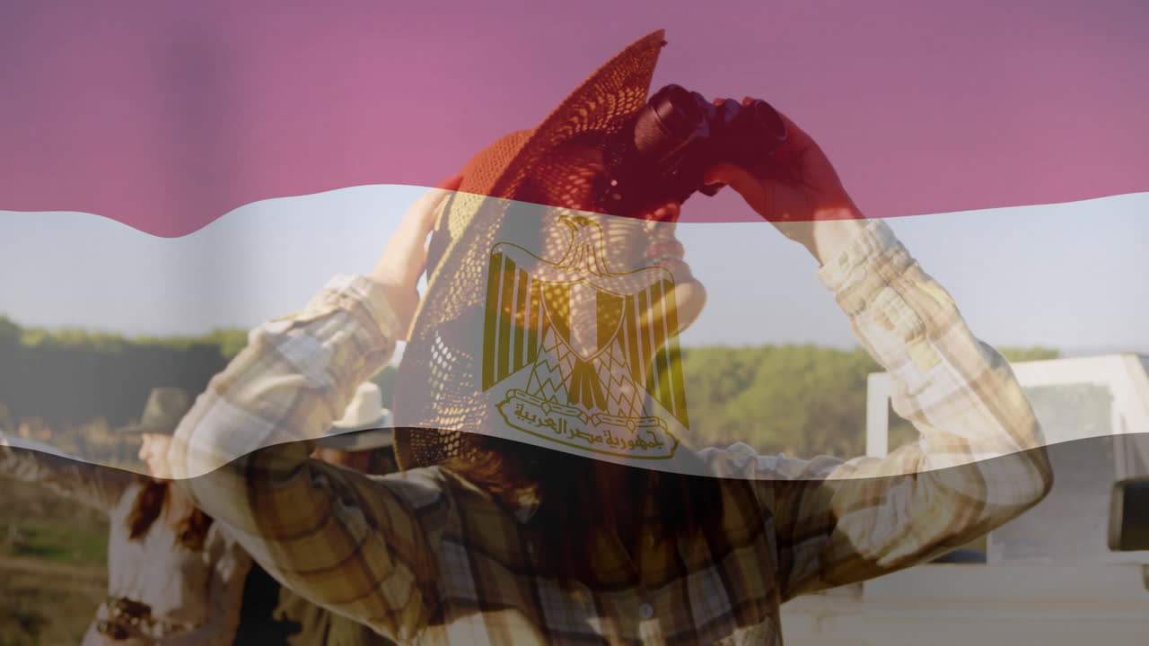 Wearing hat and binoculars, person with Egyptian flag animation overlay