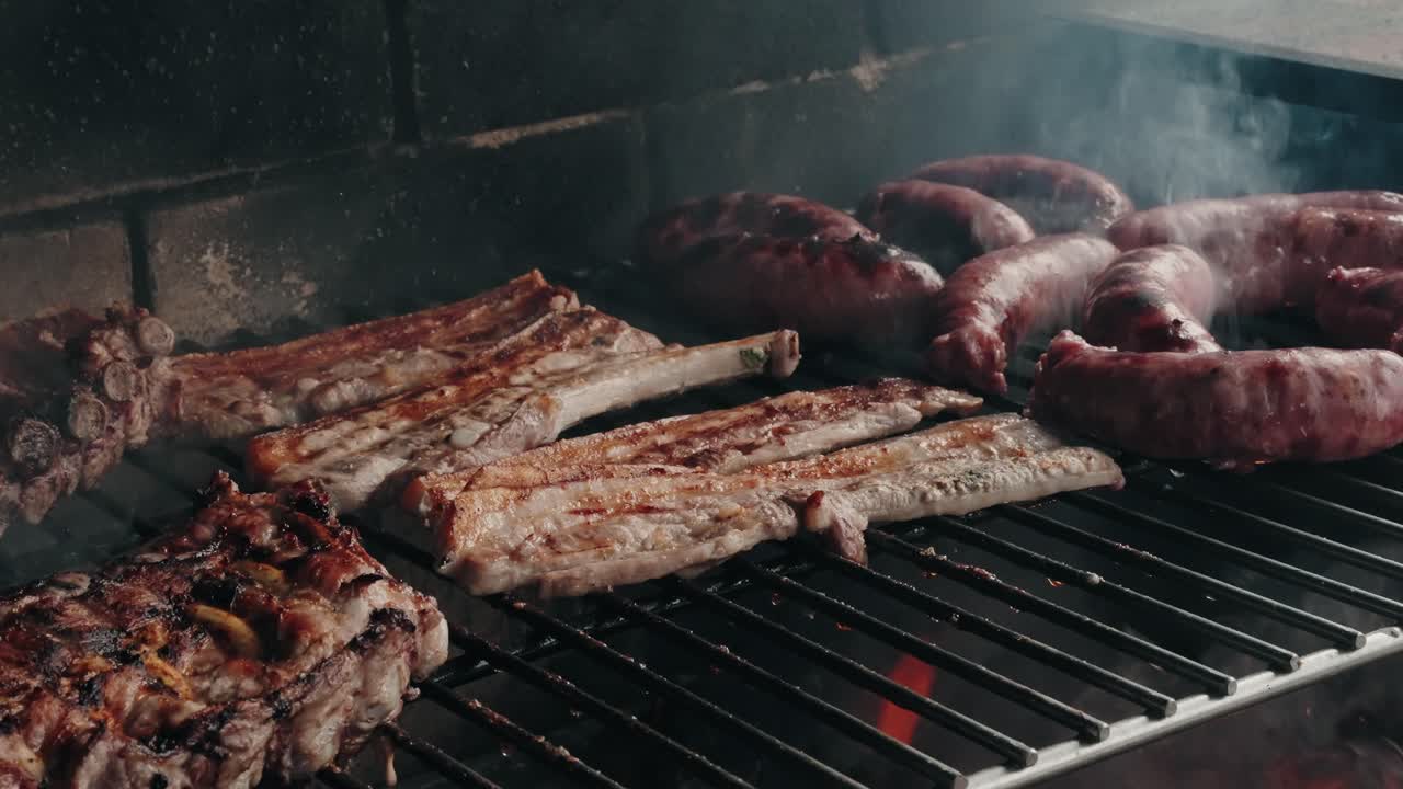 Sausages and ribs grilling on open flame barbecue location irrelevant
