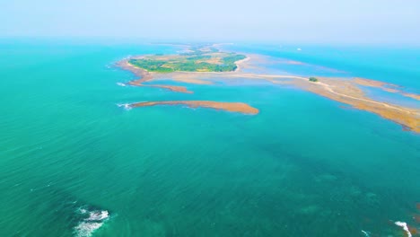 tropical empty island surrounded by turquoise ocean