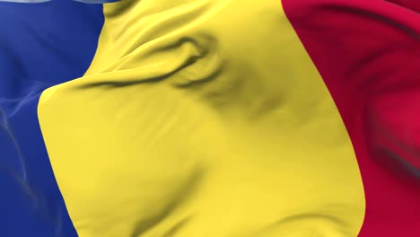 romania flag waving at wind in slow with blue sky, loop