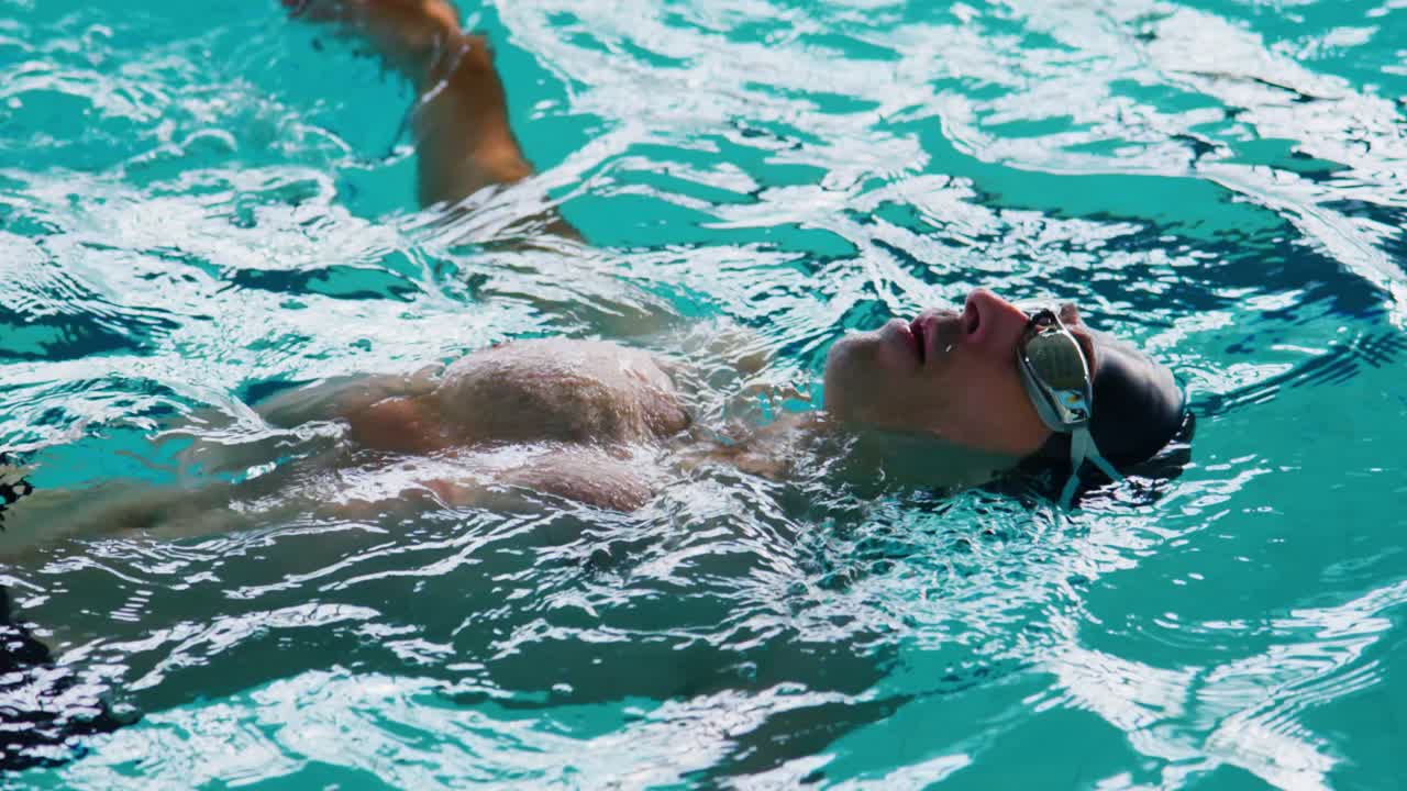 A Swimmer Floating Relaxedly in a Pool, Showcasing Technique and Serenity in Crystal Clear Water with a Focus on Breathing and Relaxation