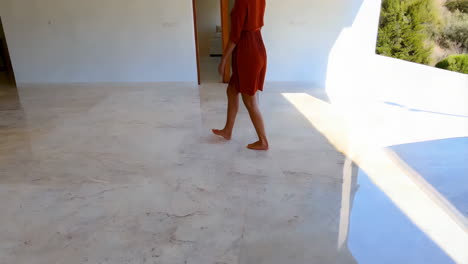 woman walking barefoot on a modern marble floor in a luxurious home