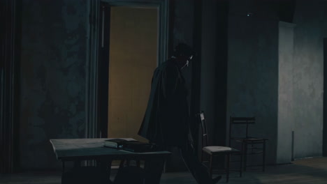 Man walking in a dark room