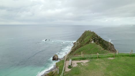 Slowly-reveal-shot-of-Ermita-de-la-Regalina,-a-small-chapel-on-a-cliff-on-the-Cantabrian-Sea,-in-the-province-of-Asturias-in-Spain