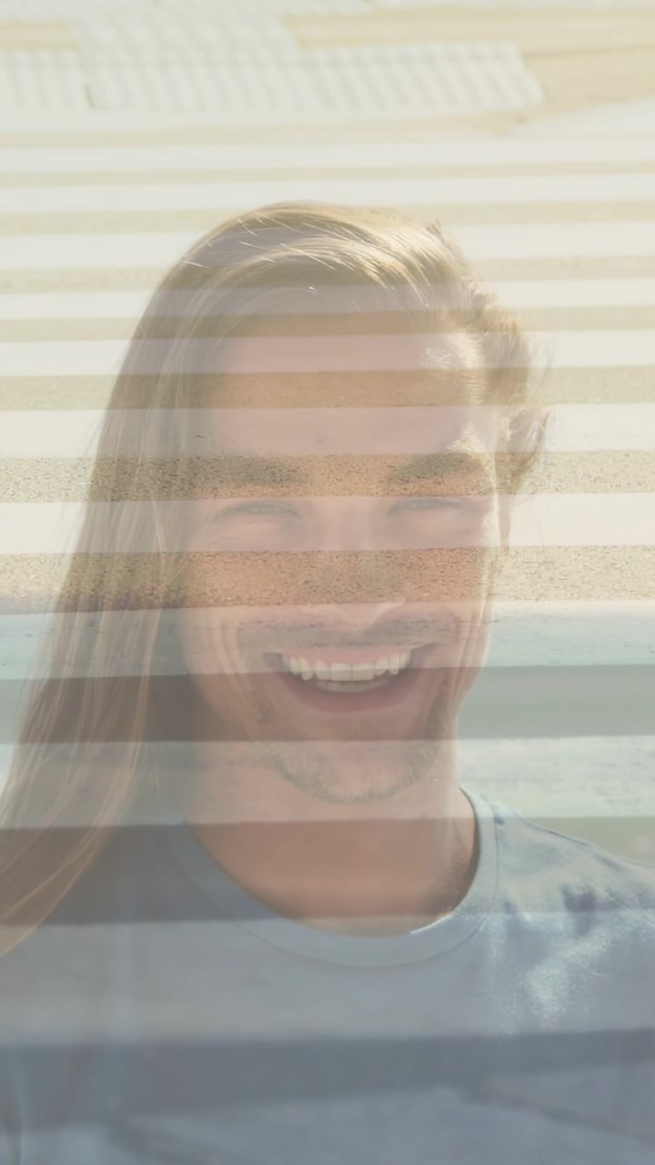 Design camera focusing on man, causing smile widening into long laugh, bands merging man and beach