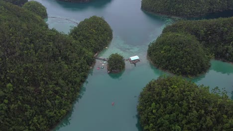 aerial overhead shot of the sugba lagoon with tourists enjoying paradise in the philippines