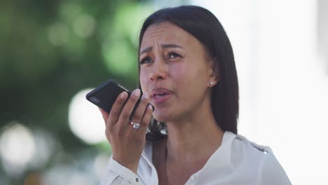 african american woman talking on smartphone in street