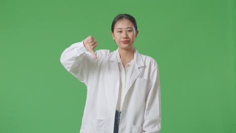 woman in lab coat giving thumbs down