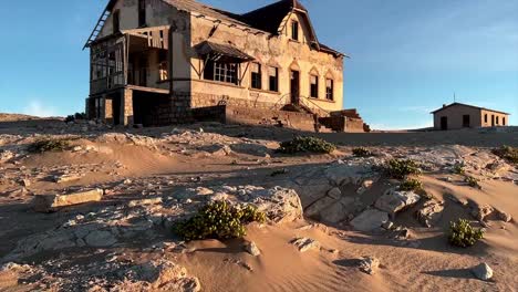 An-abandoned-ruin-of-a-house-stands-in-Kolmannskuppe-in-the-Namib-desert-of-Southern-Africa