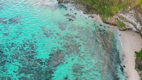aerial of turquoise tropical coastline at uluwatu bali indonesia during sunset