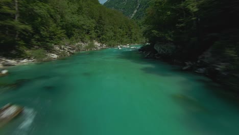fly over emerald green colour water of soca or isonzo river in western slovenia