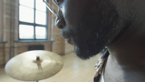 african american musician drumming on rehearsal