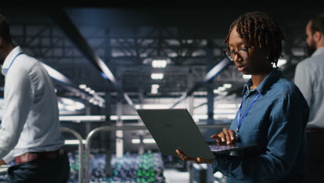 data scientist in server farm reviewing neural network code