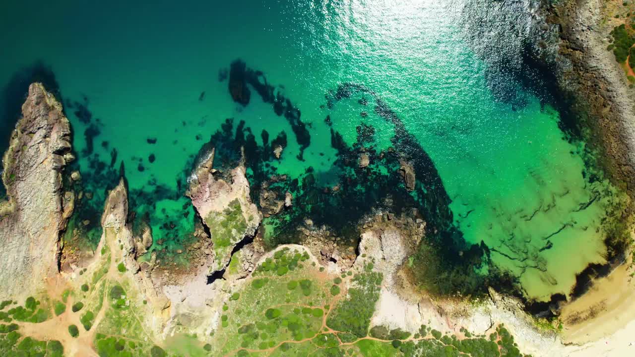Top View Of Rugged Sea Cliffs At Praia do Amado In Algarve Region, Portugal. Aerial Shot