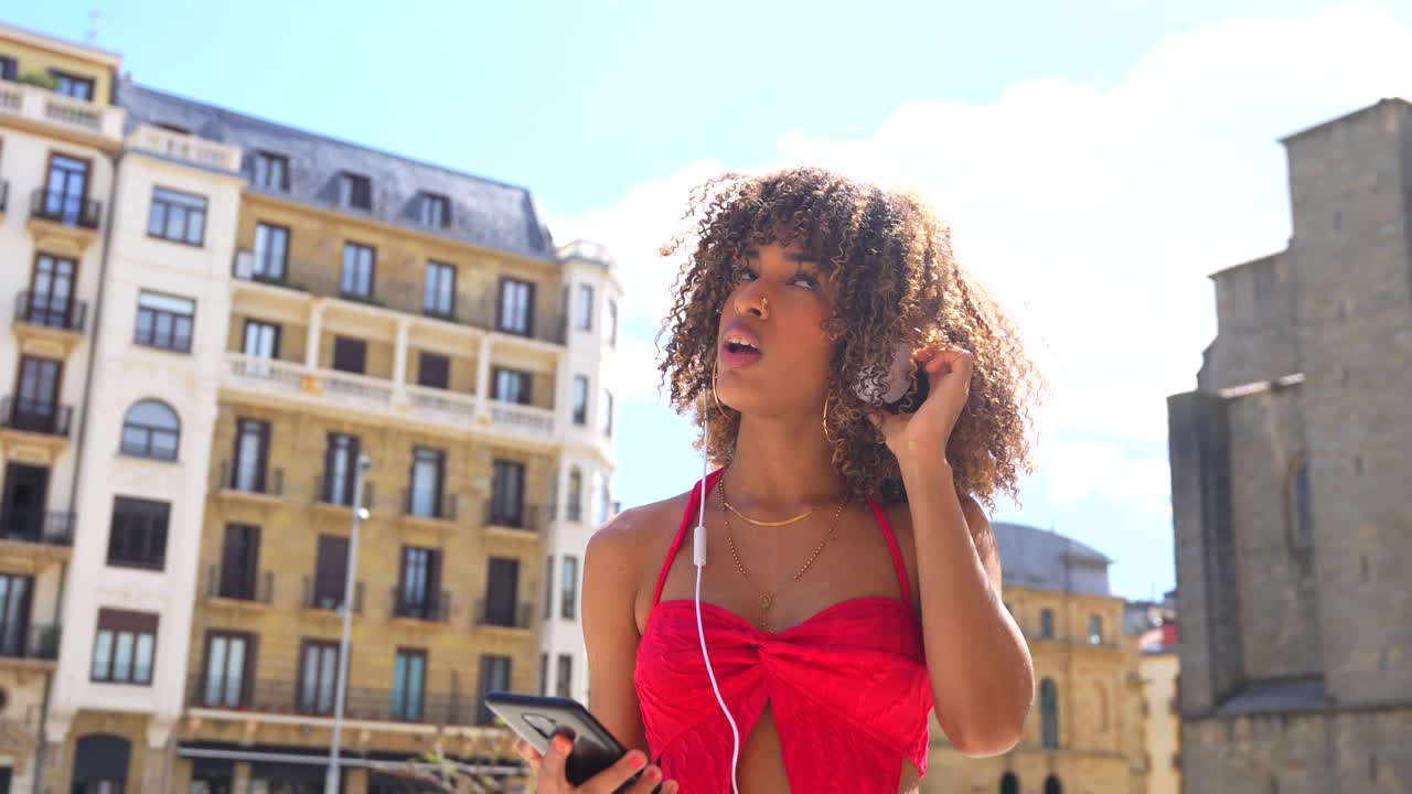 mujer escuchando música en la ciudad