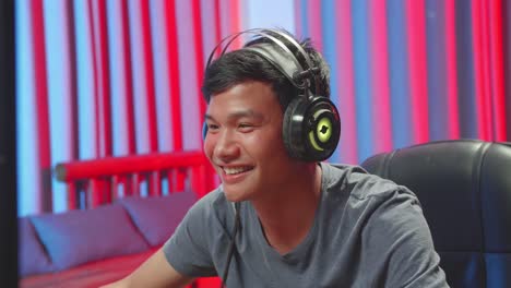 asian man playing video game