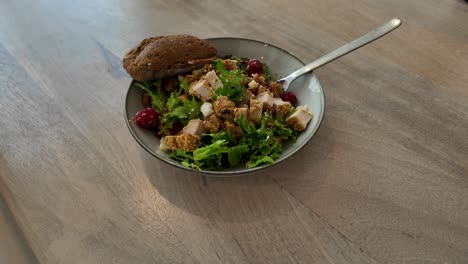 healthy chicken salad with raspberries, feta, pecans, and vinaigrette beautifully served in a bowl - vibrant colors dynamic movement