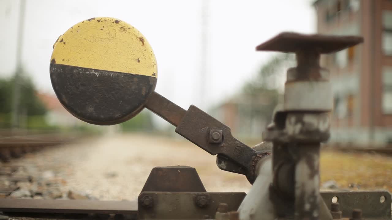 Close-up of a railway semaphore signal with panning camera effect, overcast day