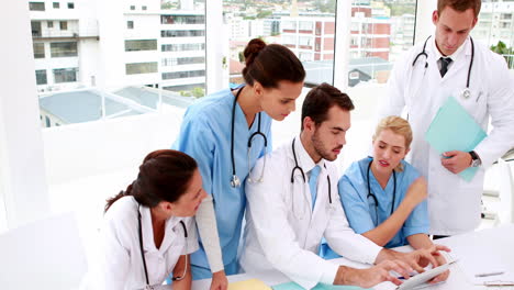 medical team looking at tablet pc during meeting