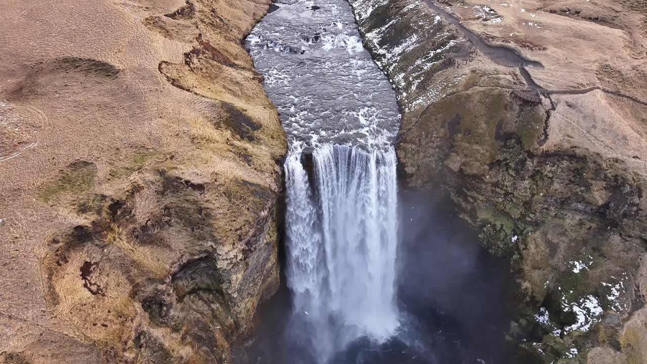 aerial - Skógafoss waterfall crashing into gorge near Eyjafjallajökull Iceland