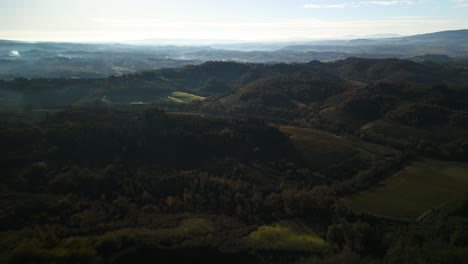 Schneller-Luftwagen-über-Sanften-Toskanischen-Hügeln-Und-Bergen,-Die-Mit-Nebligem-Nebel-überzogen-Sind