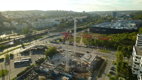 Two-Tower-Cranes-At-The-Construction-Site-Near-The-Riviera-Center-Shopping-Mall-At-Gdynia,-Pomeranian-Voivodeship,-Poland-On-A-Sunny-Day