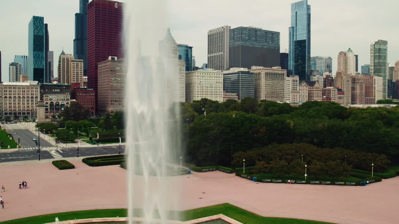 Épica vista aérea del paisaje de Chicago, con la Fuente de Buckingham lanzando agua a alta presión en cámara lenta