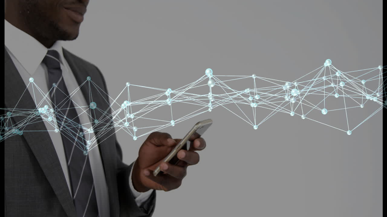 Animation of network of connections over biracial businessman using smartphone
