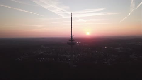 aerial shot of kiel transmission tv tower with a reddish evening sky