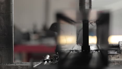 drilling hole on a metal piece in a steel factory - close up, slow motion