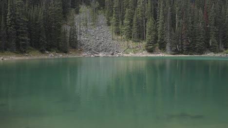 mirror lake on the hiking trail up to lake agnes tea house on mount st. piran and mount whyte, within banff national park near lake louise alberta.