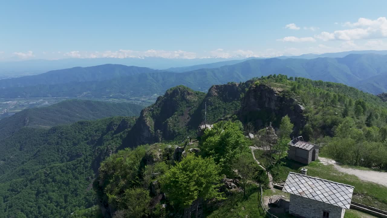 Rising aerial drone footage of Cima Bracco, a peak in the Cottian Alps of Piemonte, Italy, featuring the iconic Croce di Envie cross monument surrounded by breathtaking alpine scenery