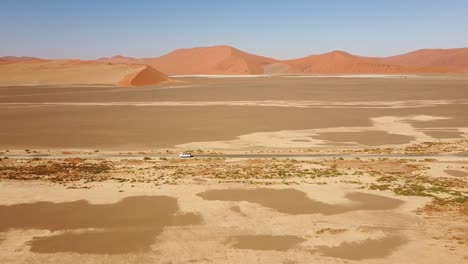 namibian self-drive wildlife adventure with a rooftop-tent equipped toyota hilux in sossusvlei's iconic sand dunes at sunset