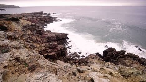 Wide-angle-view-of-waves-breaking-into-the-rocky-coastline