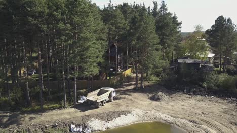 construction near a wooded area with a pond