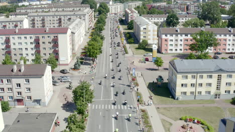 drone following a motorcycle parade in city streets