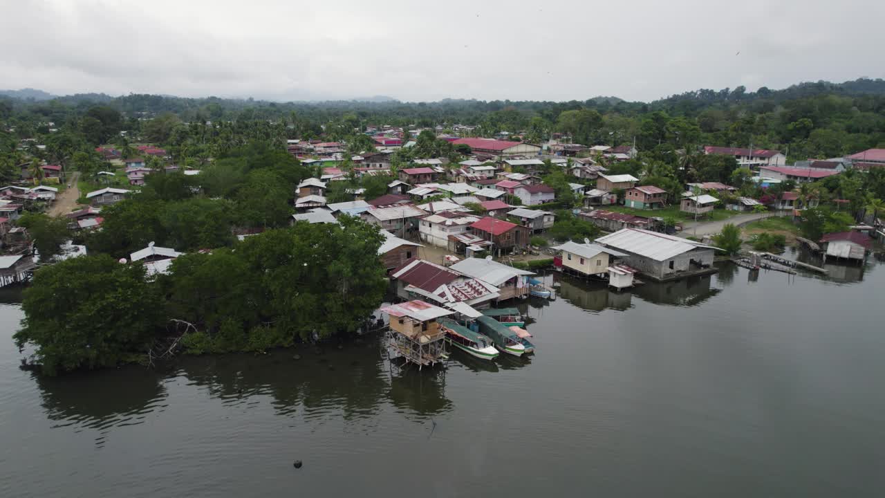 Aerial View of a Tropical Waterfront Village with Stilt Houses