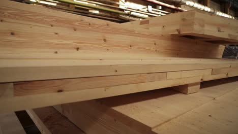 stacked wooden beams in a manufacturing facility