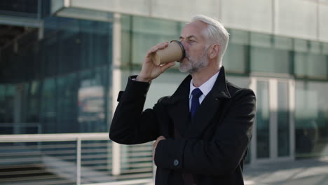 portrait of mature business man drinking coffee taking break corporate boss waiting