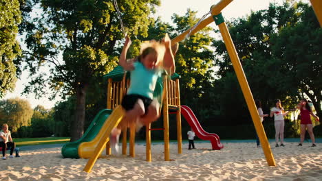 happy girl swinging on playground