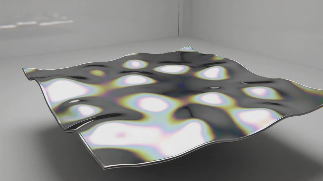 Chrome membrane receiving central impulse, rippling and rotating to show damped oscillation