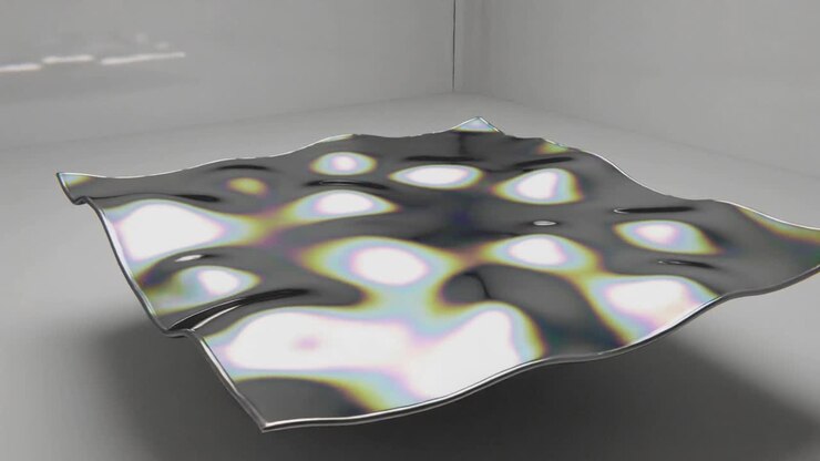 Chrome membrane receiving central impulse, rippling and rotating to show damped oscillation