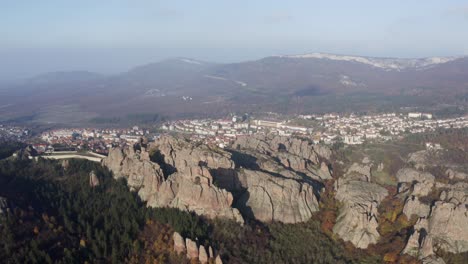 strafing from the righ to the left to show a more panoramic view of the belogradchik sculptural rocks, the town, ane the balkan mountain ranges in the background in vidin province in bulgaria