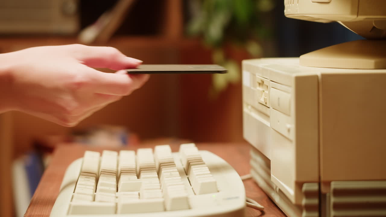 Inserting a floppy disk into an old computer