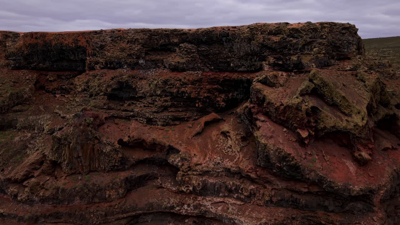 Mirador de Gayo showing volcanic rock formations and stratified red earth layers