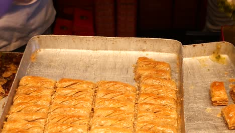 close-up of freshly made baklava being prepared by a chef in a bakery