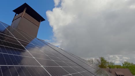 timelapse of moving clouds in blue sky with rows of solar panels