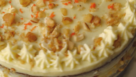 delicious carrot cake with chopped walnuts and fresh carrot bits on top, macro